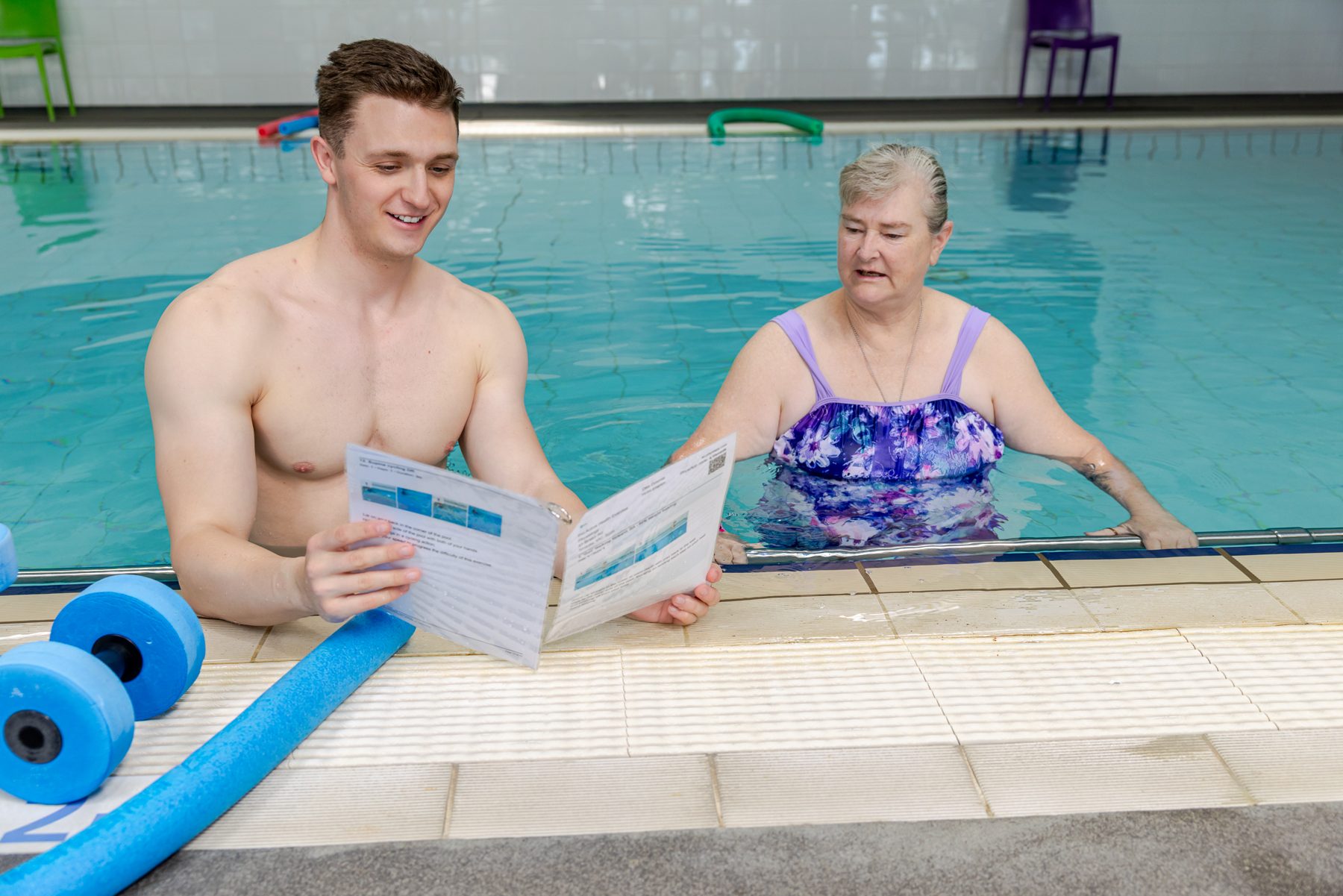 Reviewing a hydrotherapy plan at the pool edge